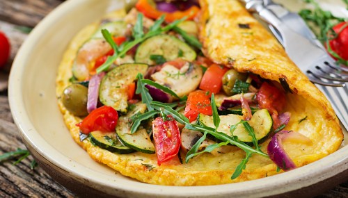 Omelet with tomatoes, zucchini and mushrooms.